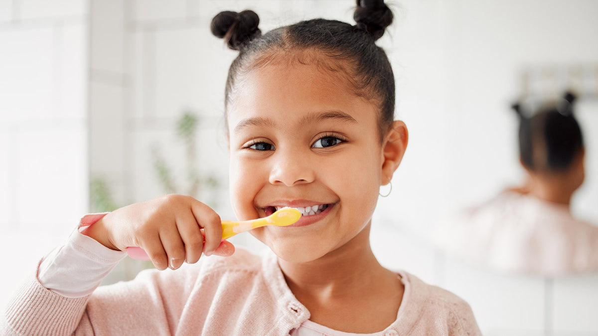image of a girl brushing her teeth