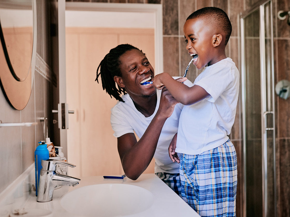 image of a father and son brushing their teeth