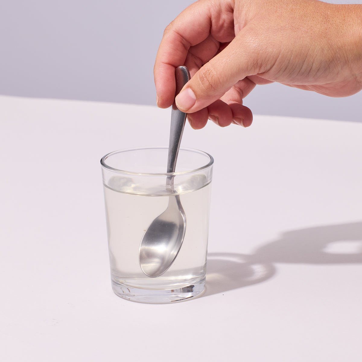 image of a person stirring with a spoon