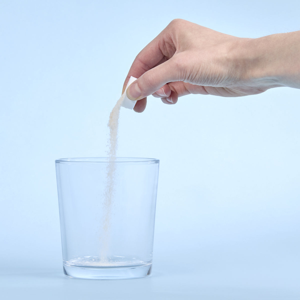 image of a person pouring Isotonix Digestive Enzymes with Probiotics in a cup