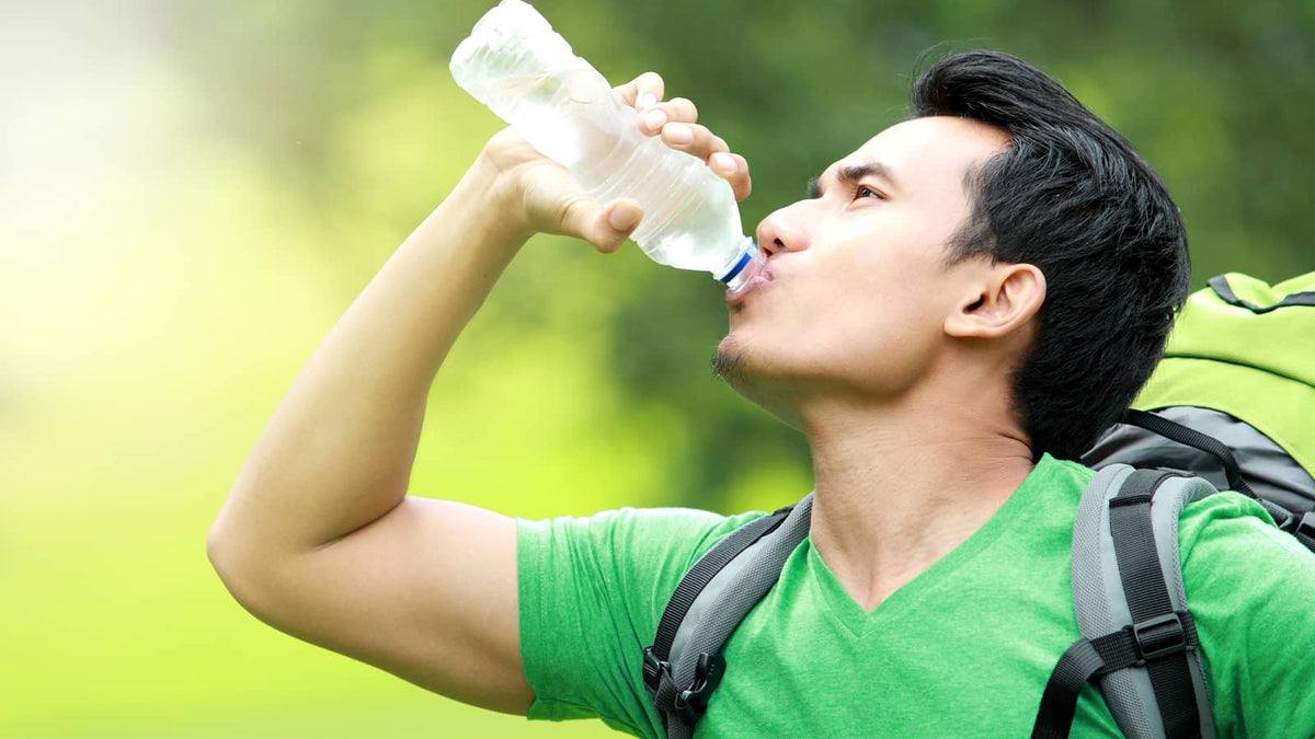 image of someone drinking out of a water bottle