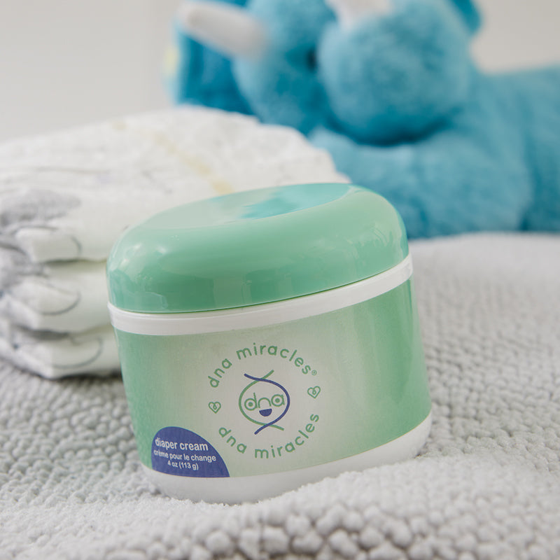 DNA Miracles Natural Diaper Cream with diapers and a blue Teddy Bear