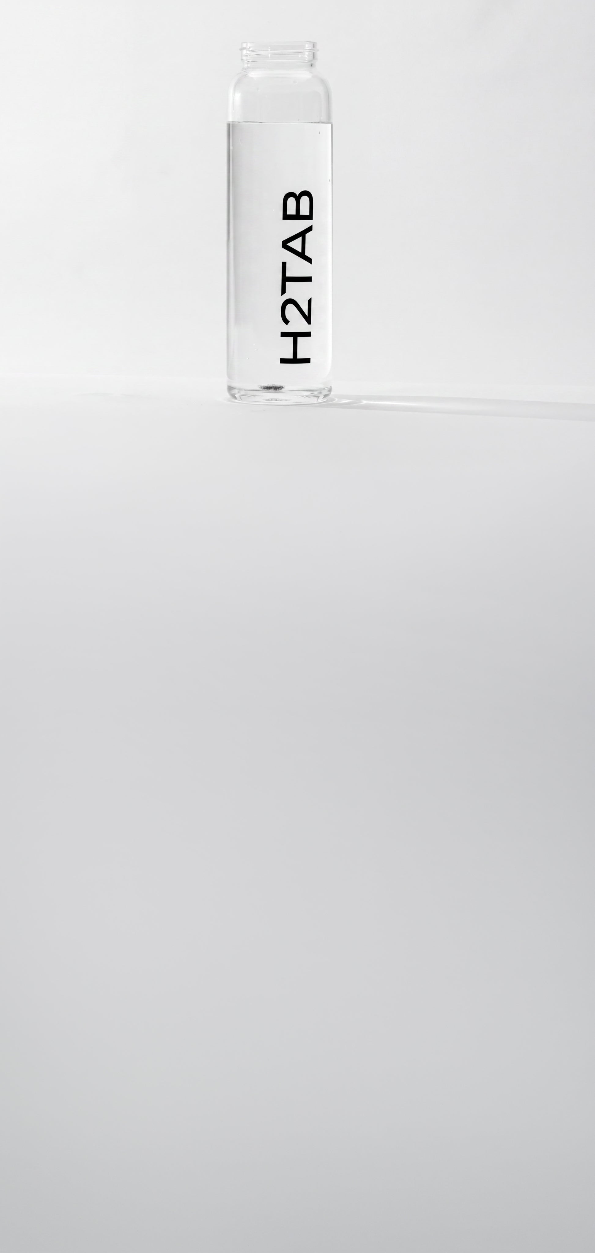 A clear cylindrical bottle with a white cap, featuring the brand name 'H2TAB' printed vertically in black on the front, set against a plain light gray background.