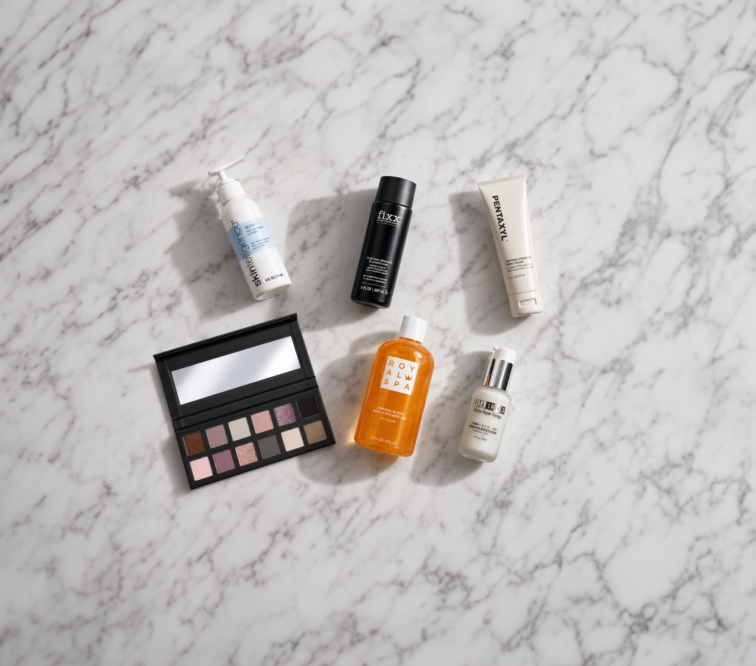 Collection of skincare and makeup products on a marble surface