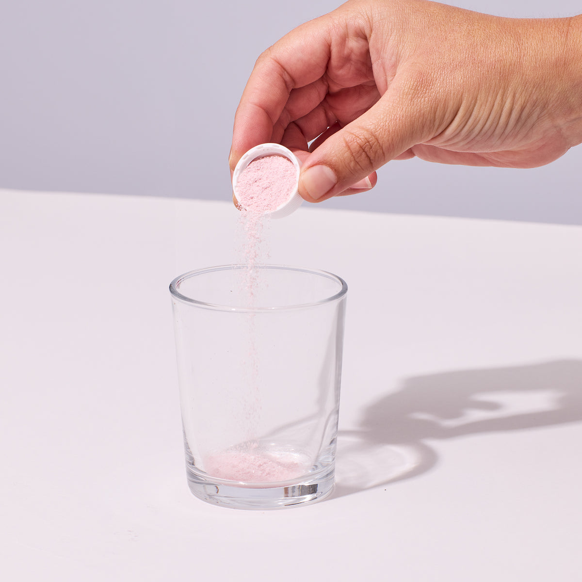 person pouring one serving of Isotonix Immune into a glass