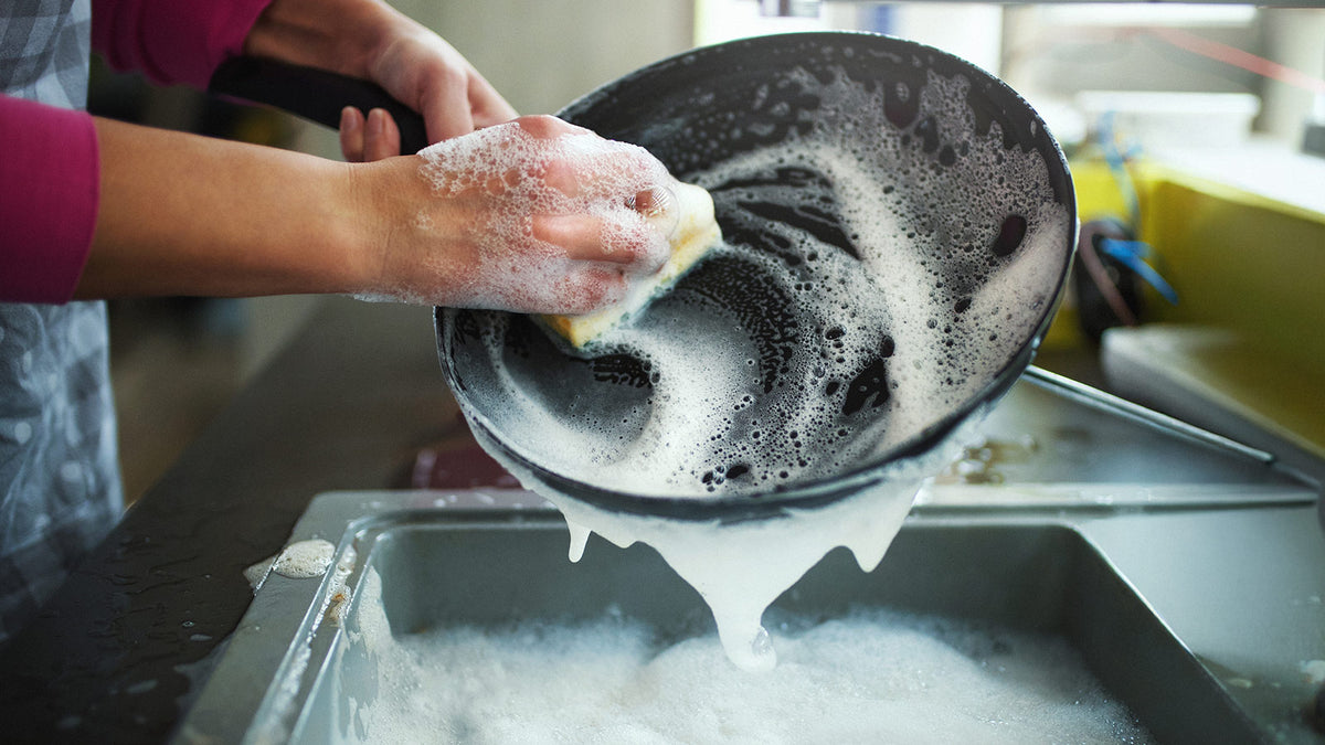 image of someone washing dishes