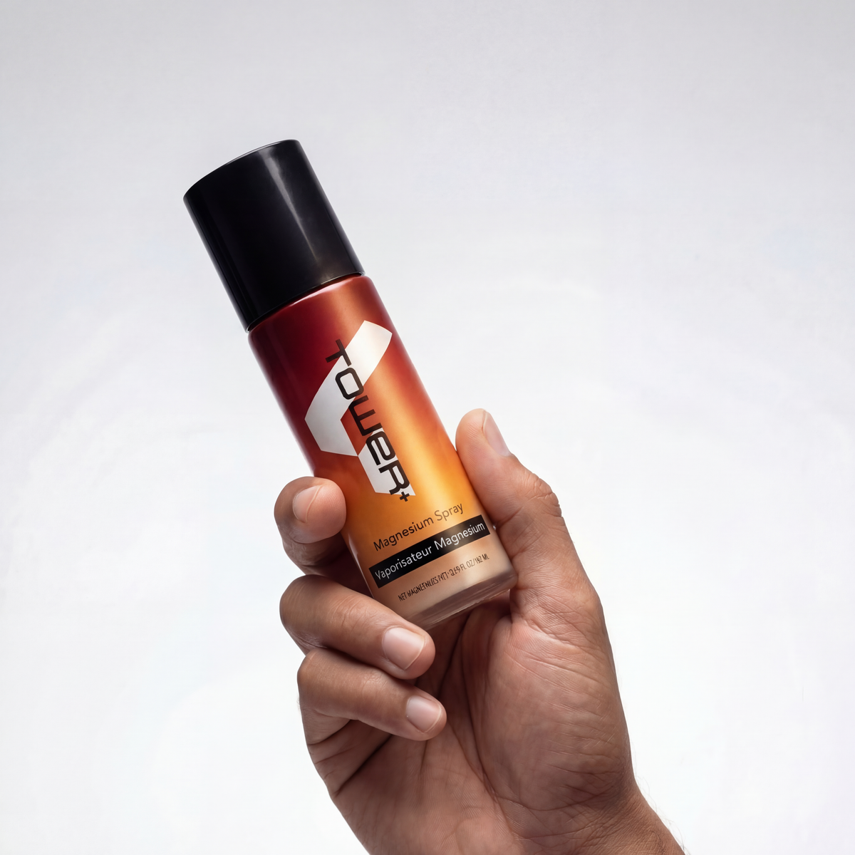 A hand holding the spray
