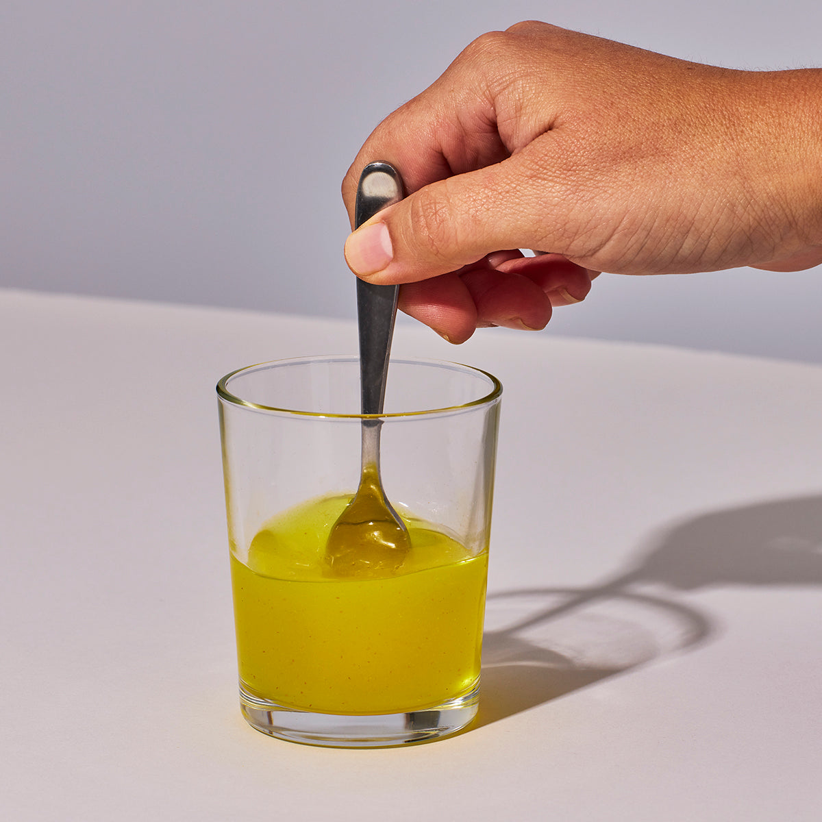 image of someone mixing up one serving of Isotonix Isochrome powder with water