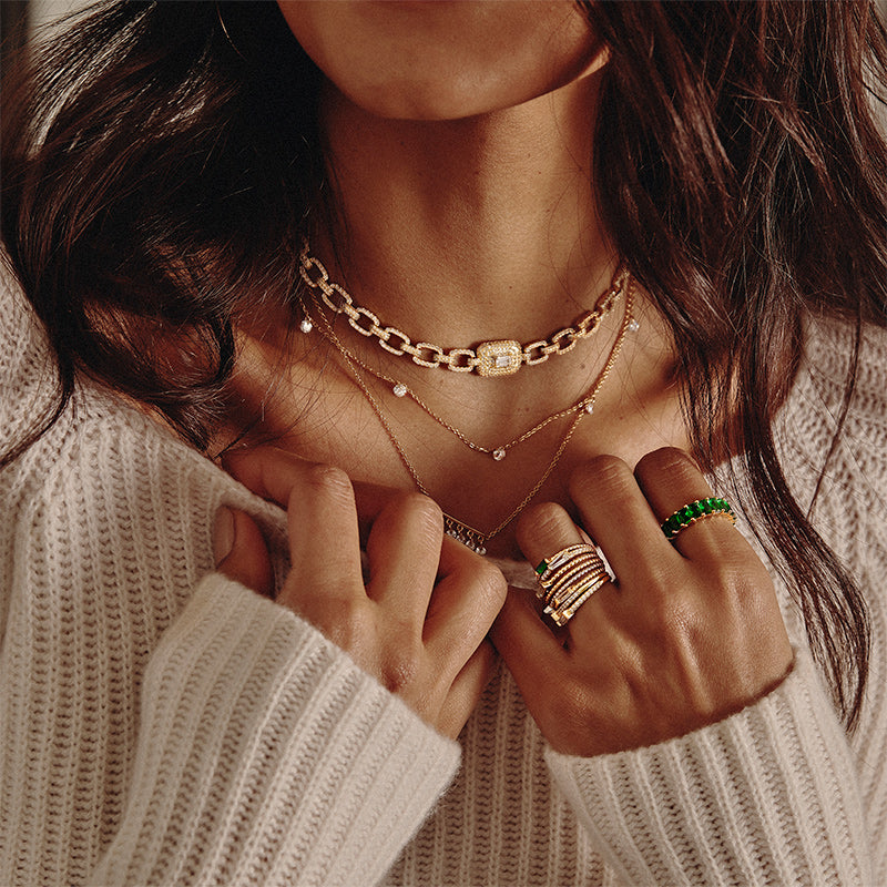 Model wearing examples ofDesi - Pierced Round Cut Necklace and rings