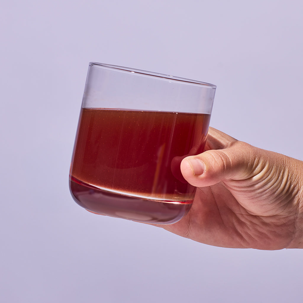 image of someone holding a glass containing one serving of Isotonix Turn Up