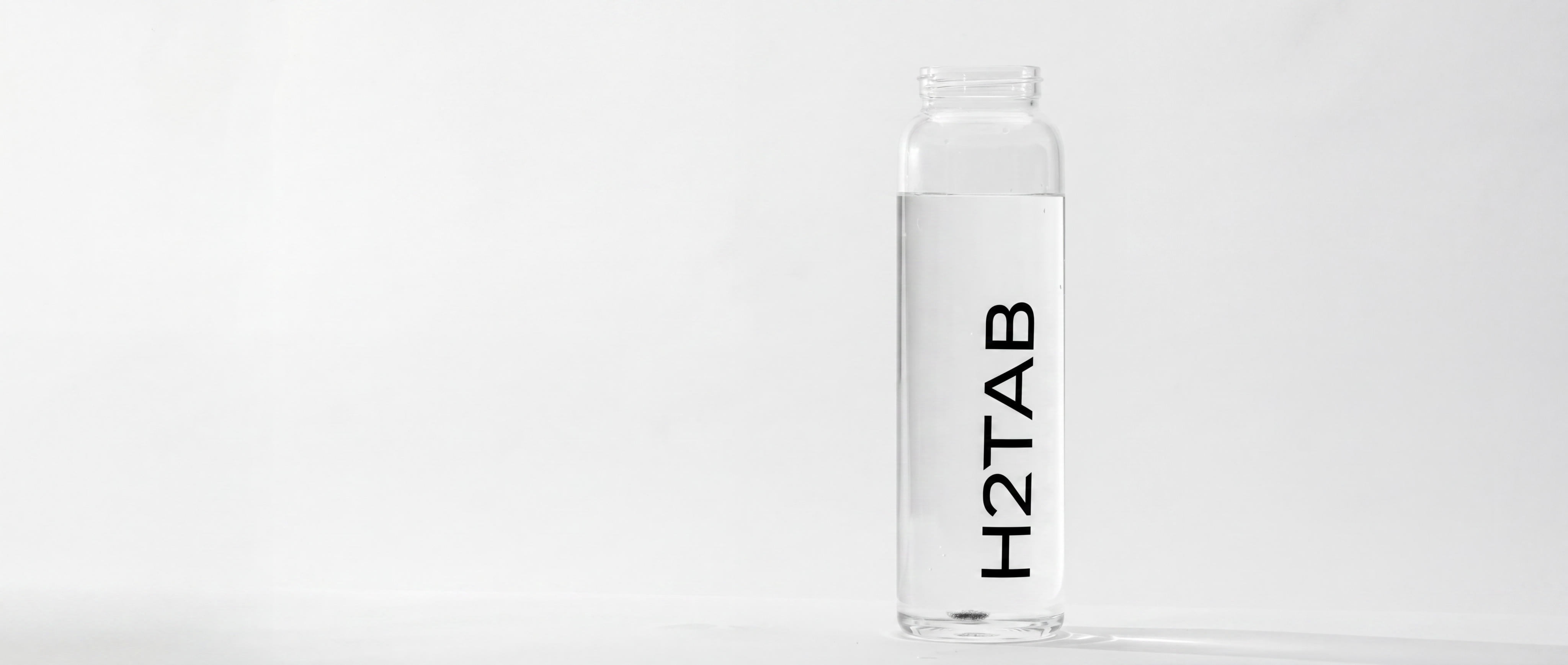 Clear water bottle with 'H2TAB' branding on a white background