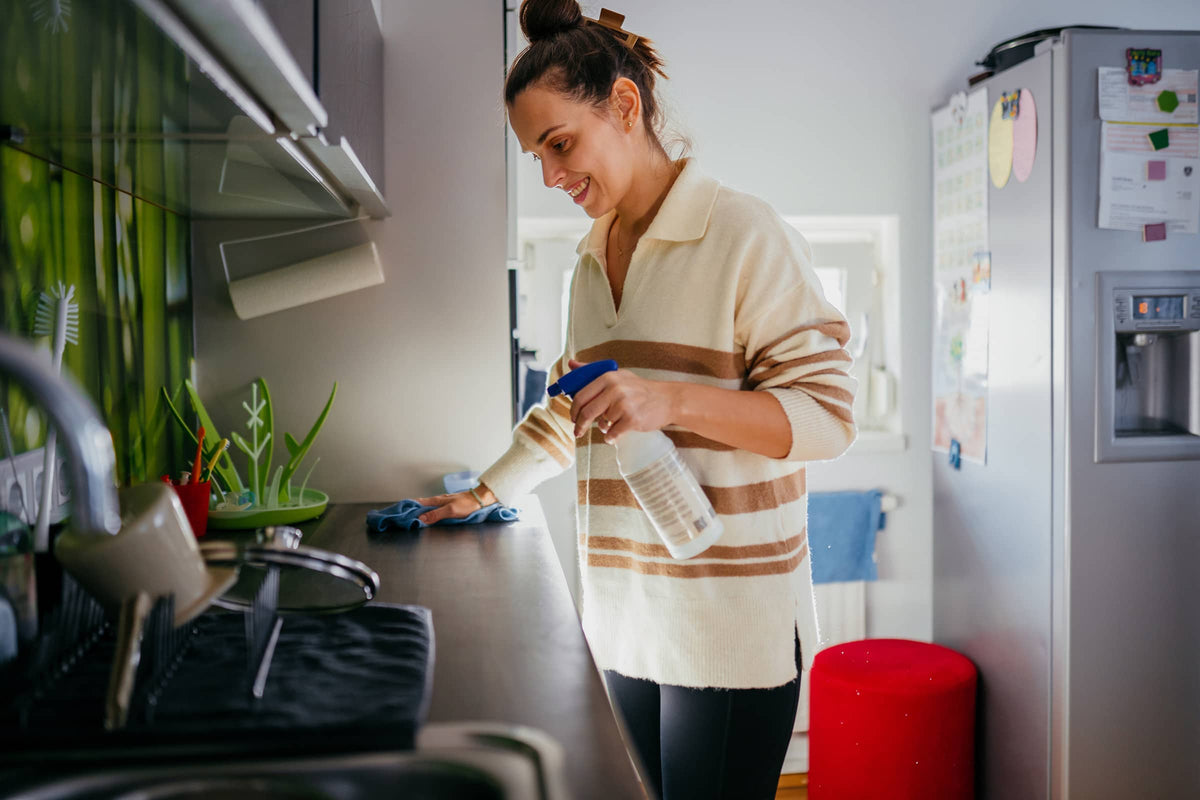 woman cleaning kitchen
