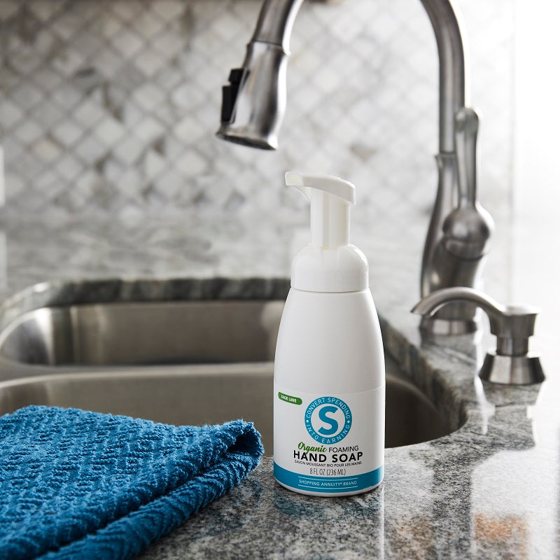 Shopping Annuity Brand Organic Foaming Hand Soap on a sink beside a blue towel