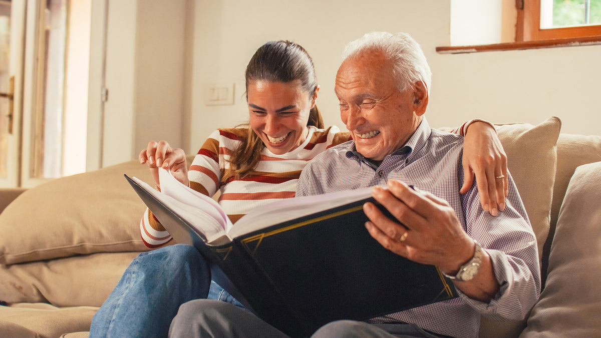 A woman reading to an elderly man