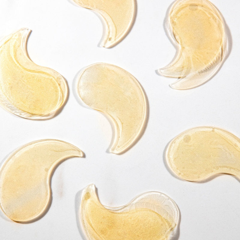 Lumière de Vie Eye Revive Gels, many pads outside container, shaped like a swooped teardrop