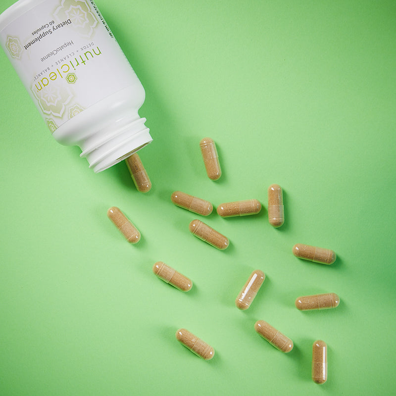 NutriClean HepatoCleanse (Liver Support Formula), caplets poured on a green table to view