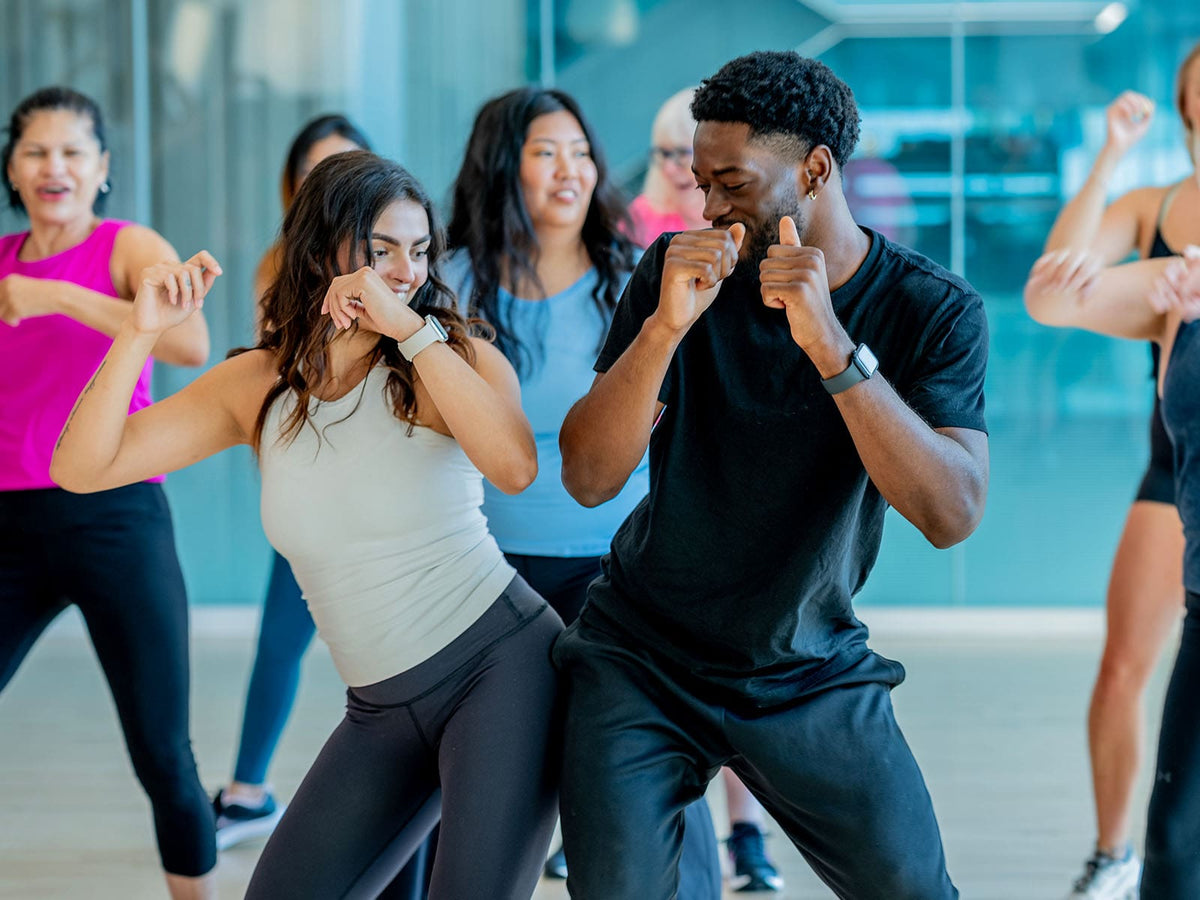 split editorial image of a group of people dancing on left and then dark acai powder falling on right