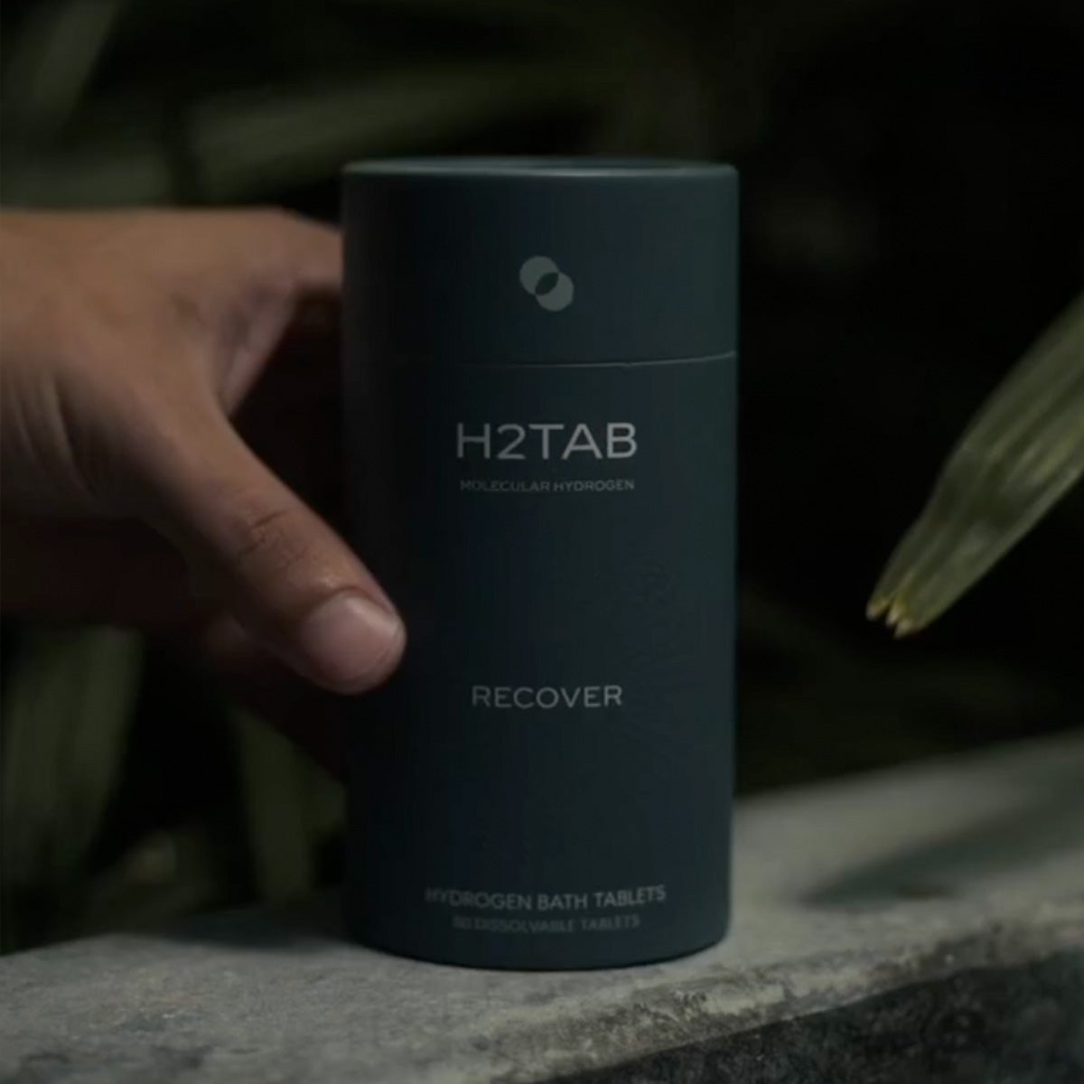 a hand is holding bath tab can