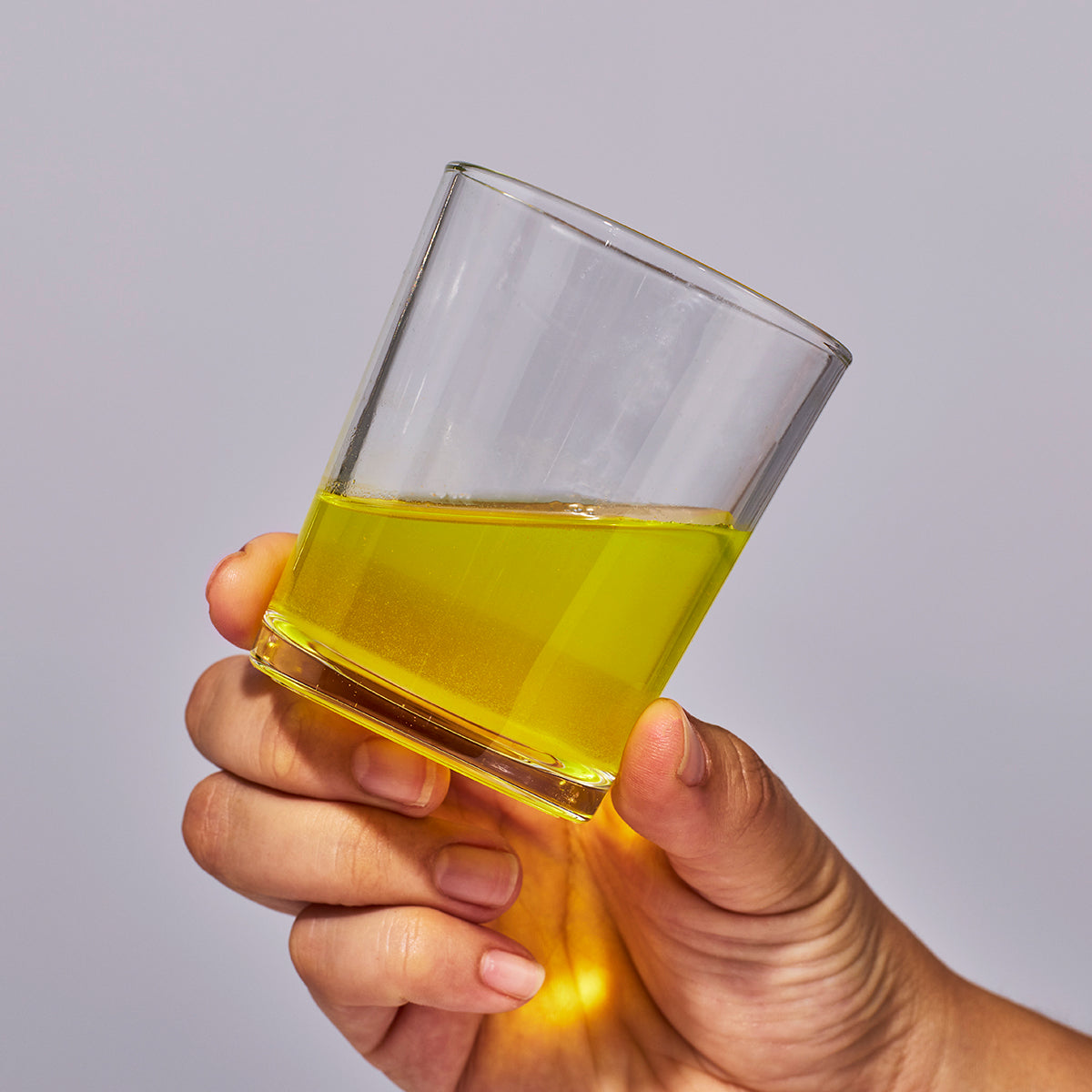 image of person holding a glass containing a serving of Isotonix Isochrome