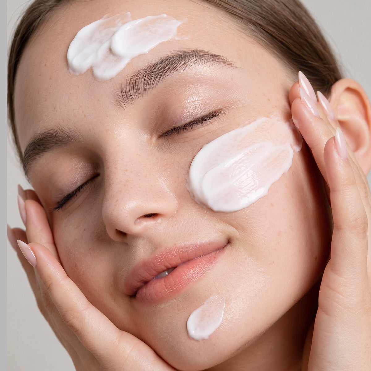 women is applying lotion on face