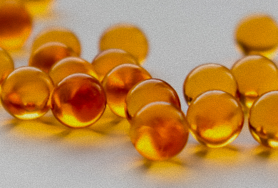 Close-up of amber-colored beads on a light gray background