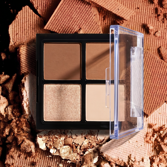 Makeup palette with four shades on a textured brown background