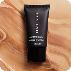 A black squeeze tube of MOTIVES Hair Advanced Repair Mask centered on a glossy, marbled beige and tan background.