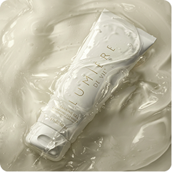 A white cosmetic tube labeled 'HUMIDIRE' resting on a glossy, creamy white surface.