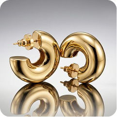 A pair of chunky, glossy gold hoop earrings with a curved, C-shaped design, displayed on a reflective surface against a gray gradient background.