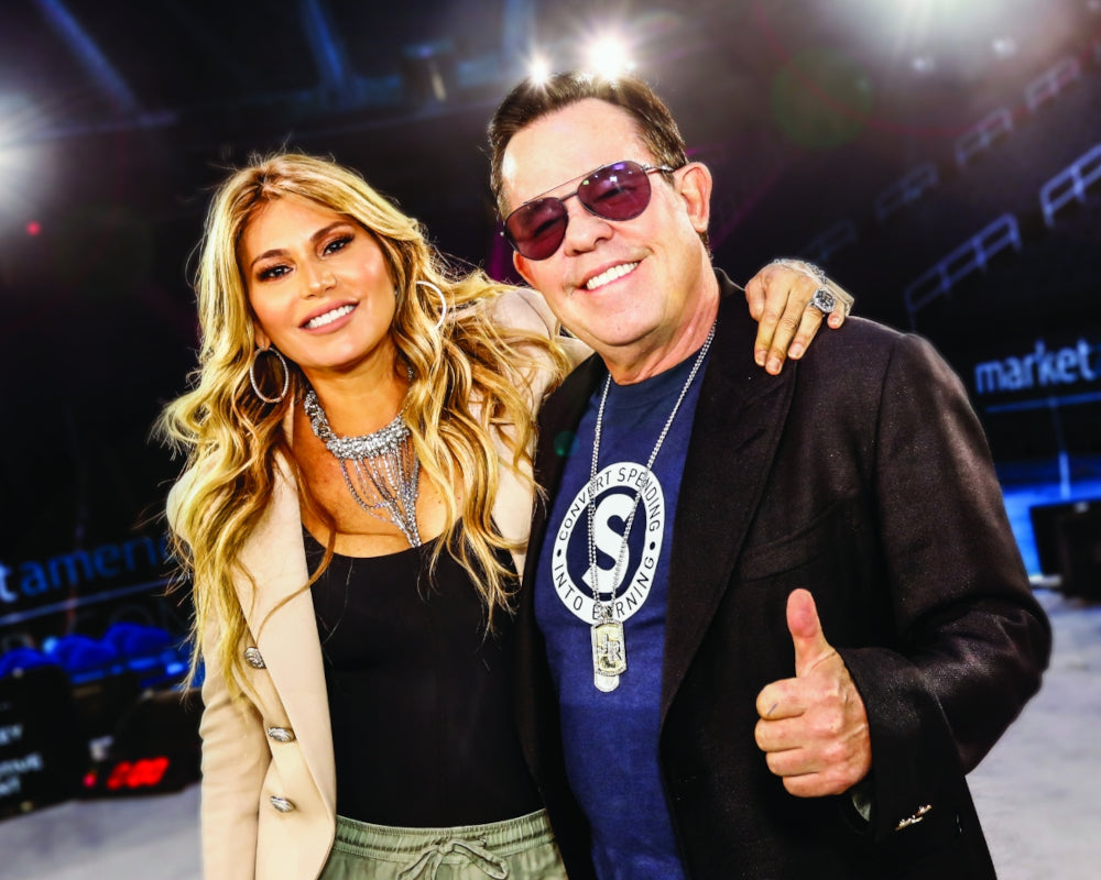 Two people posing together with a blurred background