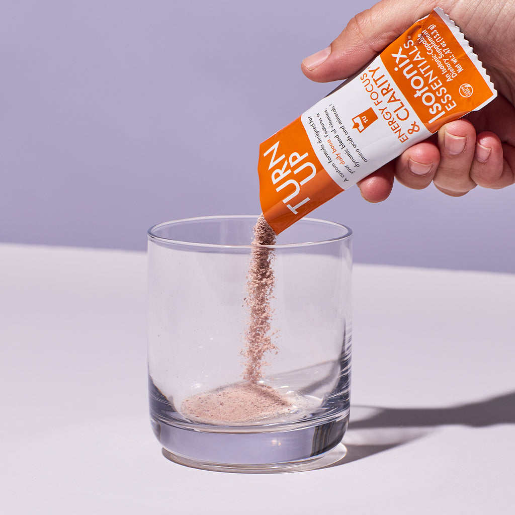 image of someone pouring a packet of Isotonix Turn Up into a glass