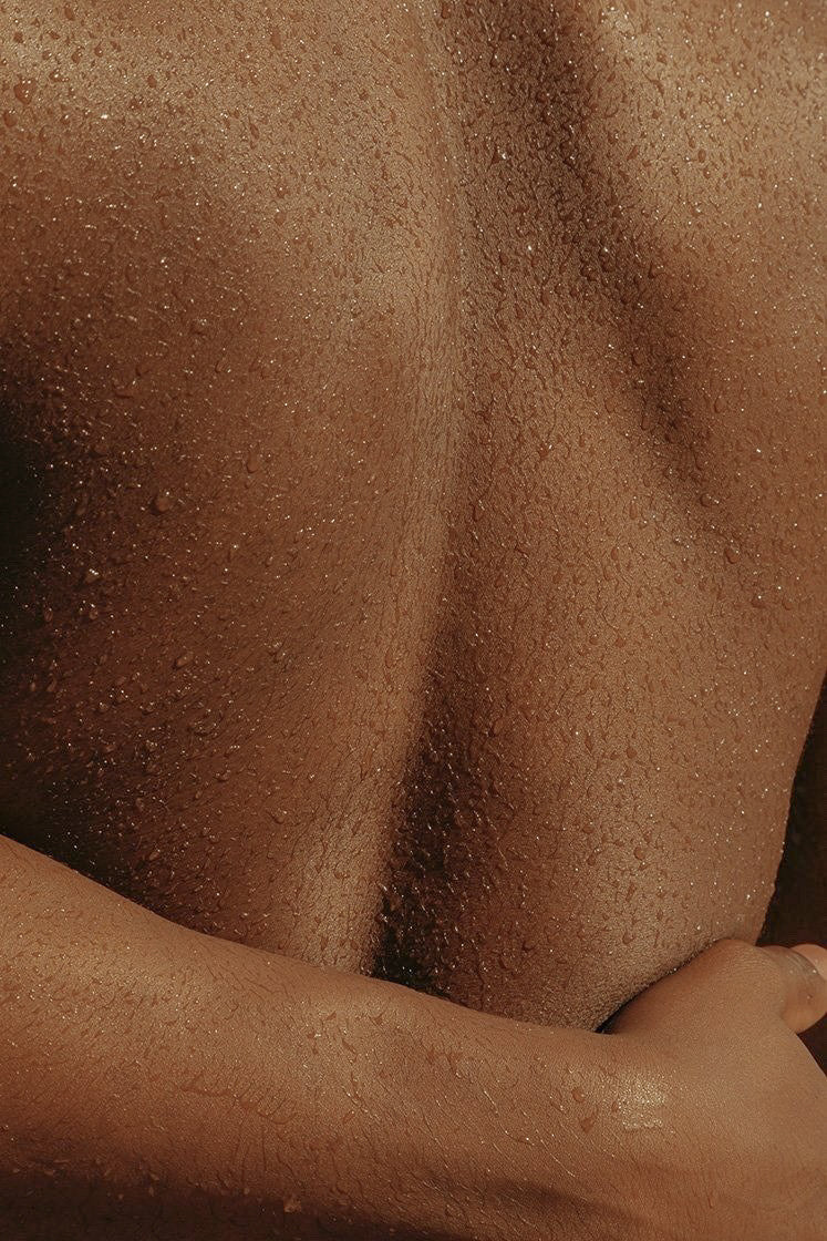 Close-up of a person's torso with a focus on skin texture.