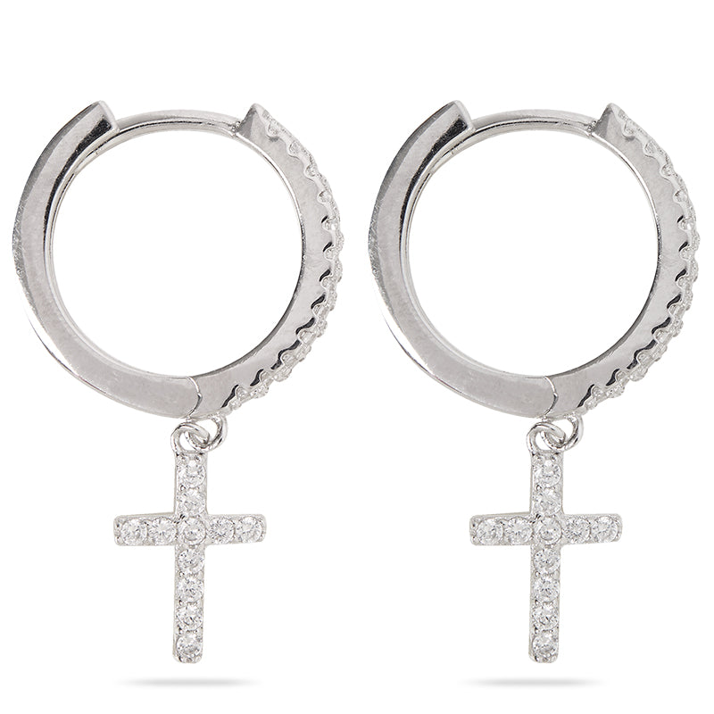 Closeup of Layered Brandi - Cross Huggie Earrings in silver, side view