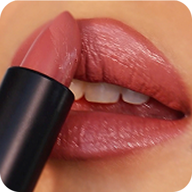 Close-up of a person applying pink lipstick with a black tube.