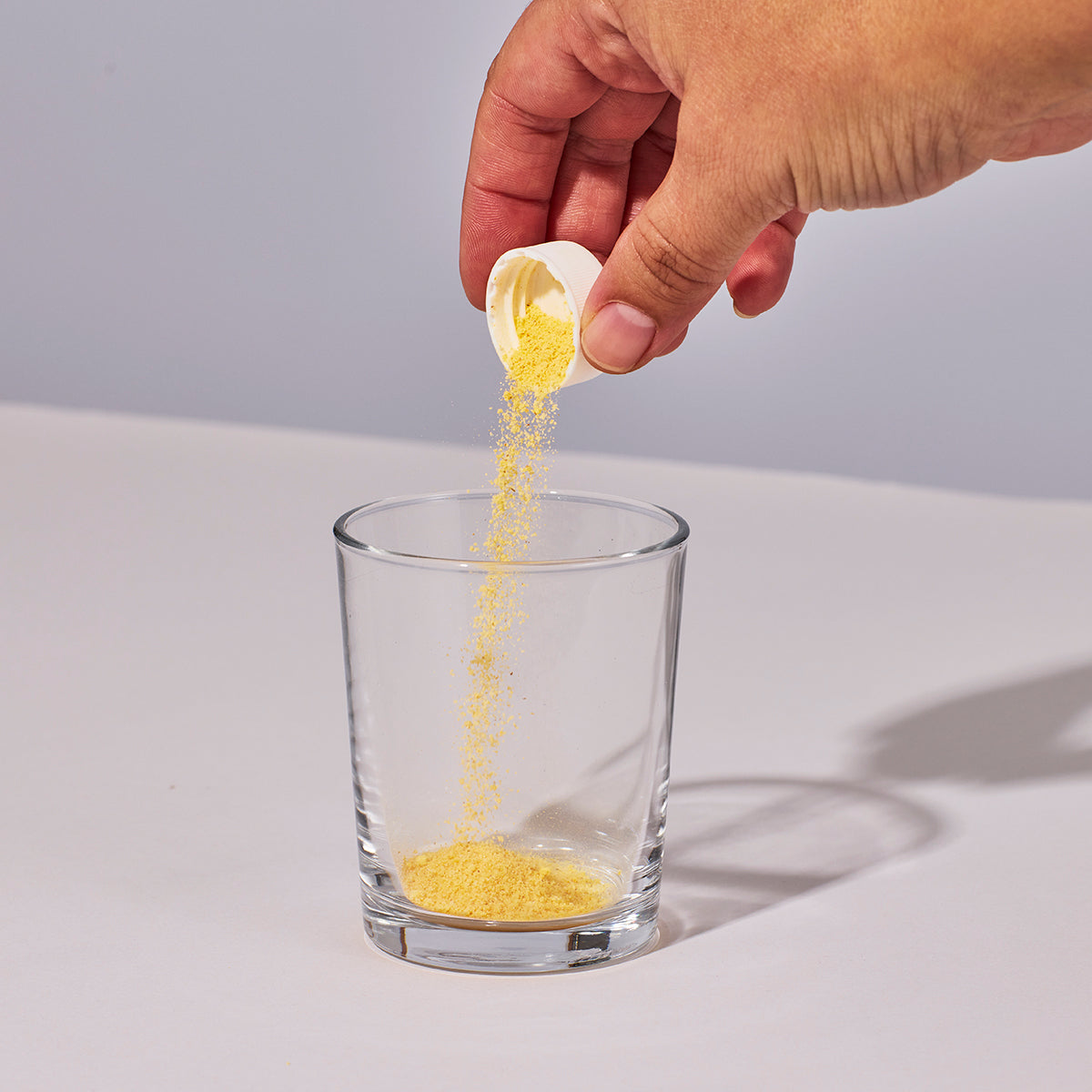 image of someone pouring one serving of Isotonix Isochrome powder into a glass