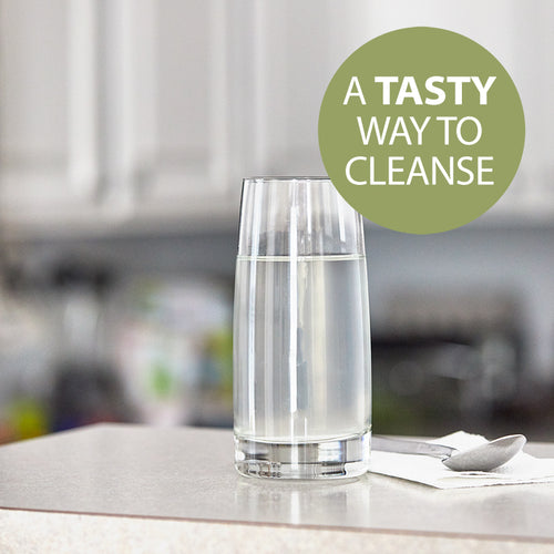 NutriClean Advanced Fiber Powder with Stevia, a tasty way to cleanse, shown mixed in a glass of water on a table with a napkin and spoon