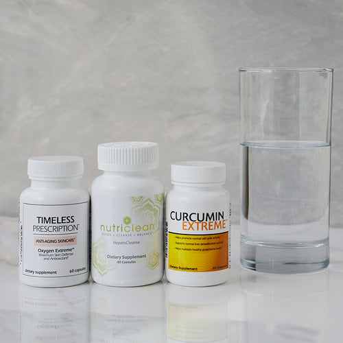 Complete Detoxification Kit: Timeless Prescription Oxygen Extreme™, Curcumin Extreme™, and NutriClean HepatoCleanse, on white table with glass of water