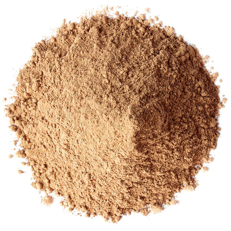 A mound of fine tan-brown powder, likely cosmetic or food-grade, photographed from above on a plain white background.