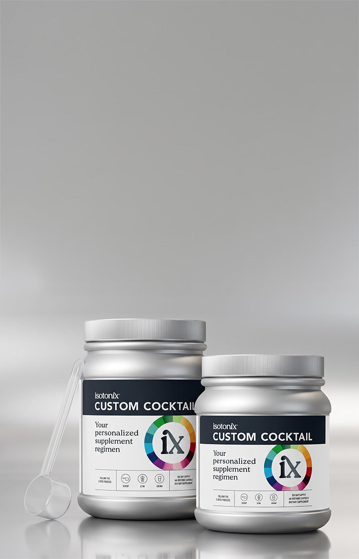 Two silver supplement jars labeled botanicx Custom Cocktail, with a white scoop resting beside them, set against a clean gray gradient background.