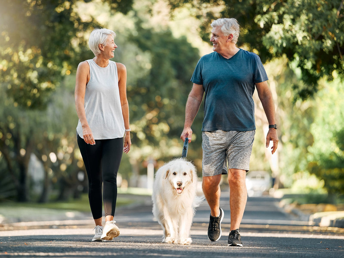 image of a man and woman walking in a park