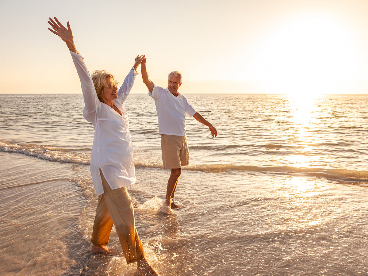 Image of two people holding hands in the sunshine