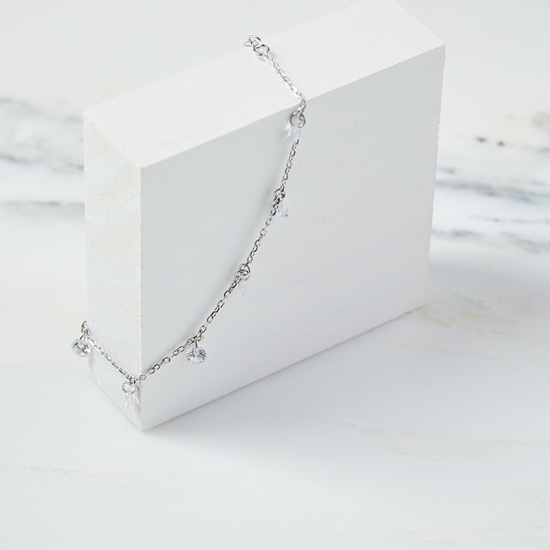 Layered Desi - Pierced Round Cut Bracelet in silver, displayed on a white box