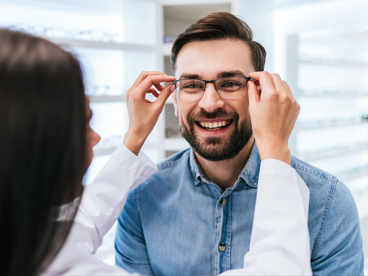 split editorial image of woman putting glasses on a man with orange yellow powder falling on right