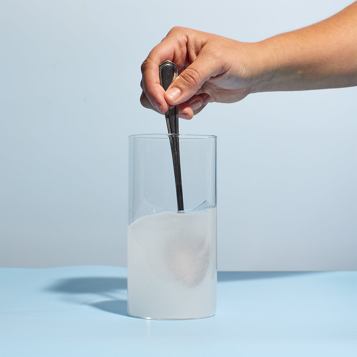 image of someone mixing a serving of Prime Creatine Monohydrate with water