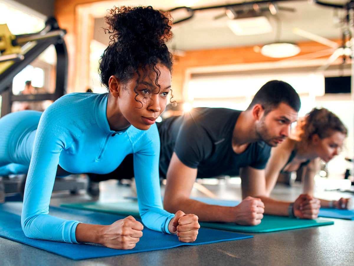 image of a group of people doing a yoga plank