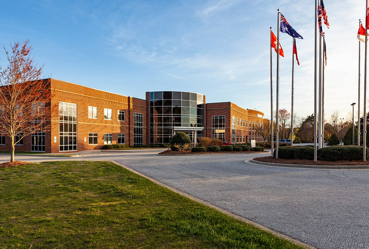 Modern office building with flags on a clear day