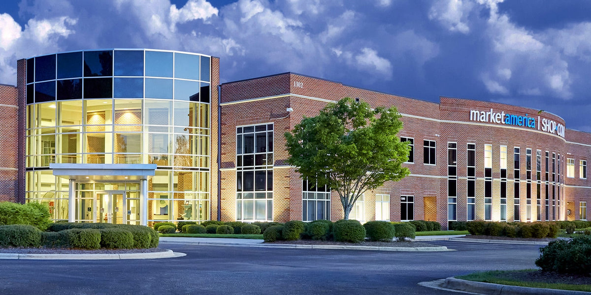 Modern office building with glass facade and 'marketcircle' sign under a blue sky.