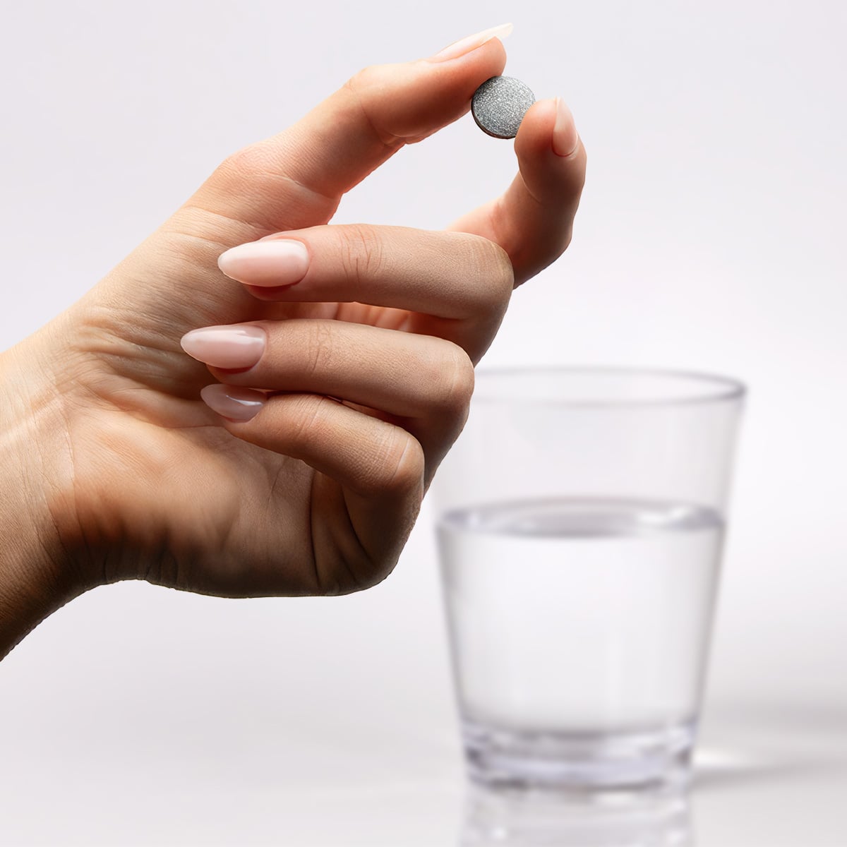image of person dropping a H2Tab into a cup of water