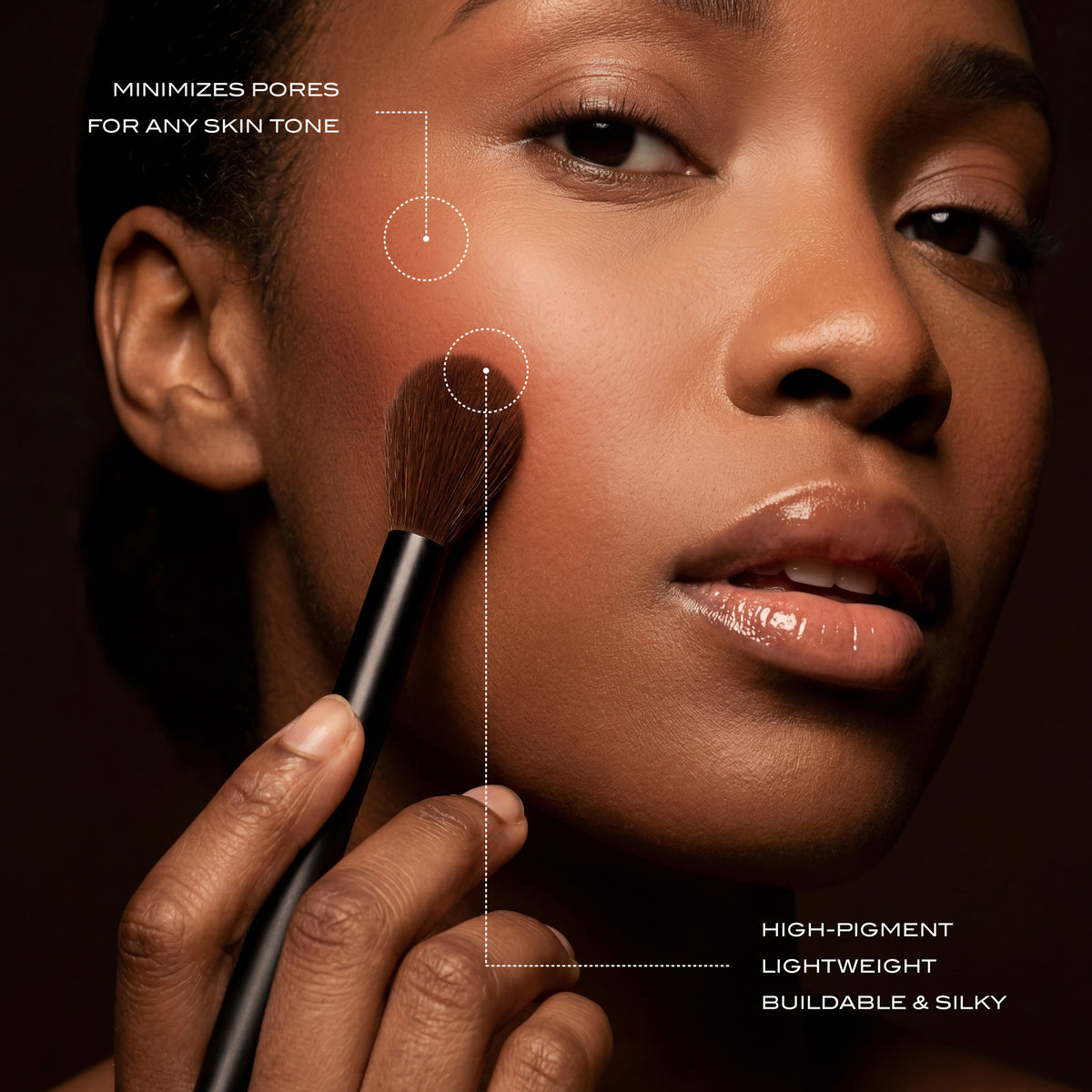 Image of woman with one of the brushes against her cheek.