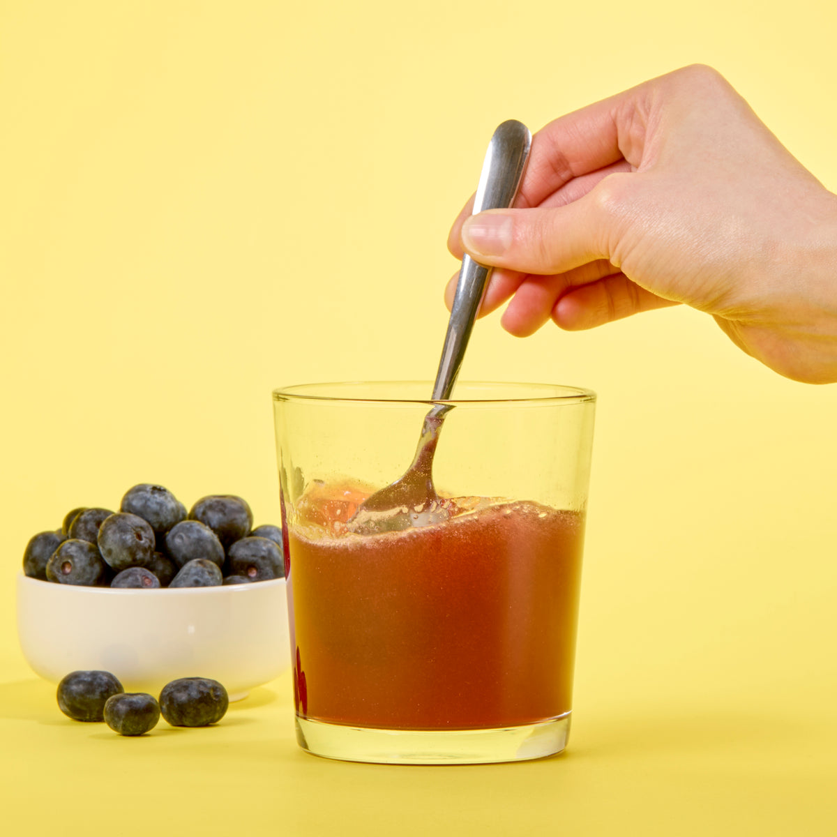 image of someone stirring Isotonix Resveratrol up with a spoon 